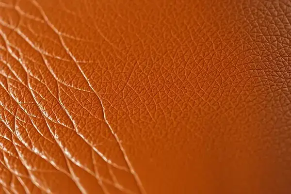 Close-up of beautifully restored leather texture showing rich brown tones and natural grain